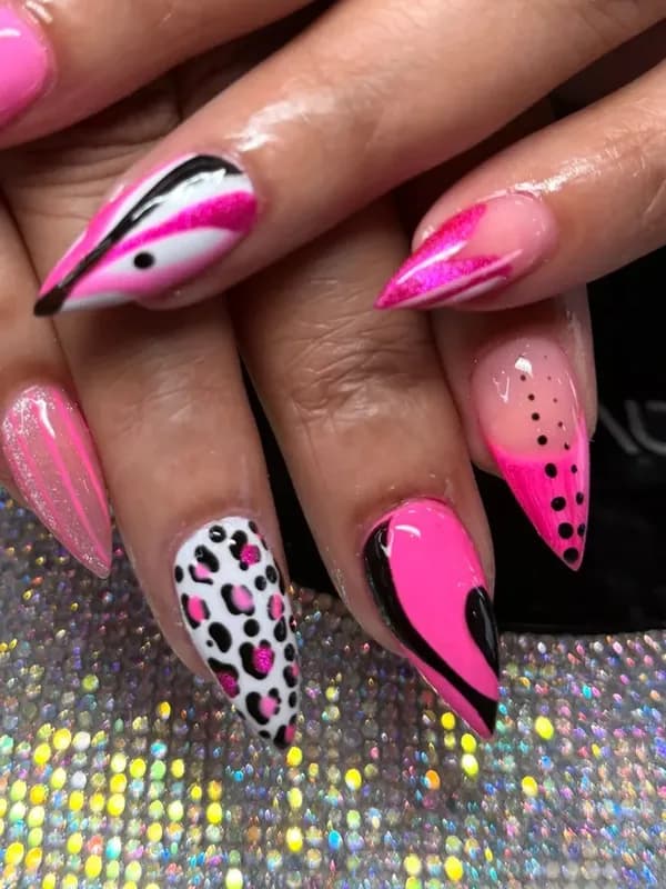 Close-up of pink leopard and swirl hand-painted nail art
